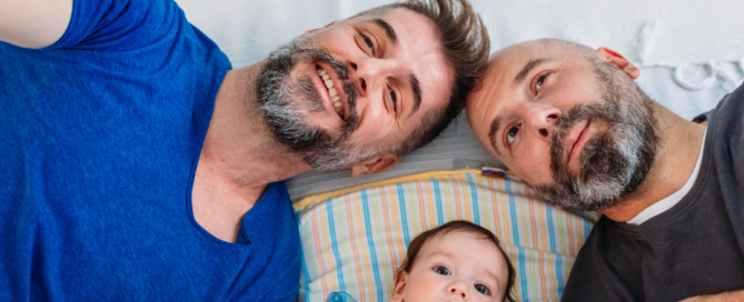 A gay couple with a baby used to illustrate family concerns in counselling.
